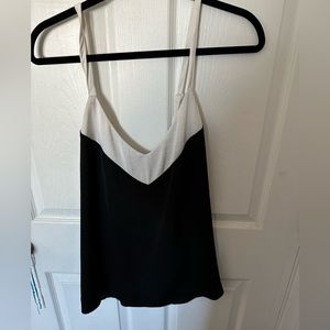 Satin flowy tank top with crossover back and a white trim